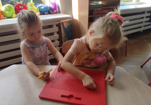 dziewczynki bawią się przy stoliku