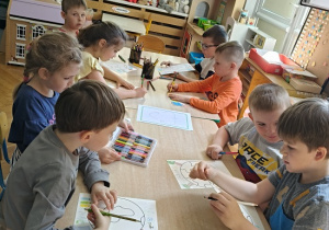 dzieci kolorują rysunek kuli ziemskiej