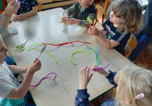 dzieci z drucików kreatywnych wykonują kwiatki