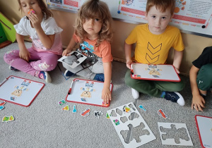 dzieci układają obrazki na tablicach magnetycznych