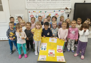 dzieci prezentują kodeks grupy na żółtym kartonie