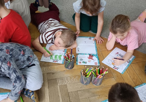 dzieci na podłodze rysują rysunki, listy do św. Mikołaja