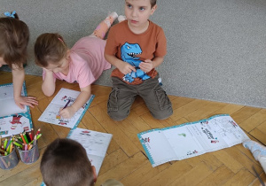 dzieci na podłodze rysują rysunki, listy do św. Mikołaja