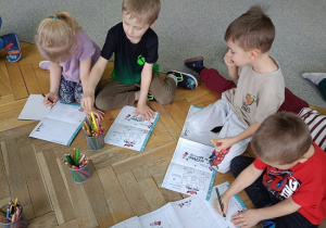 dzieci na podłodze rysują rysunki, listy do św. Mikołaja