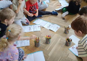 dzieci na podłodze rysują rysunki, listy do św. Mikołaja