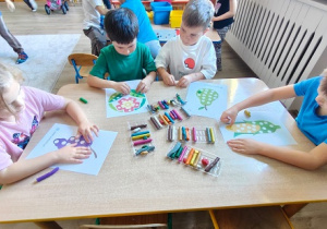 dzieci wyklejają plasteliną obrazki