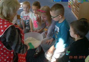 dzieci ogladają miskę z mąką